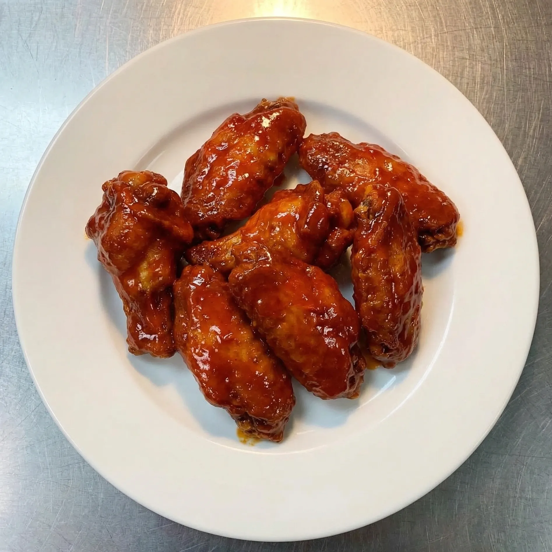 Crispy chicken wings and sides at Pangaea Pizza — honey garlic and spicy flavours in NW Calgary